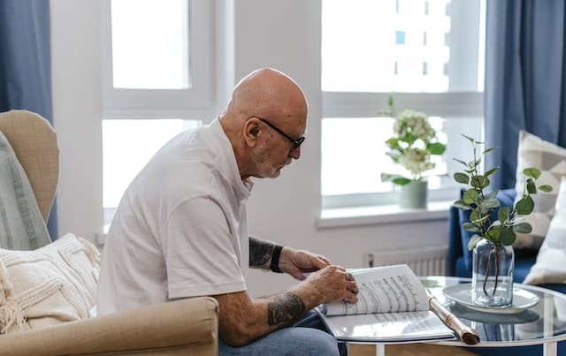 Elderly man reading a musical sheet